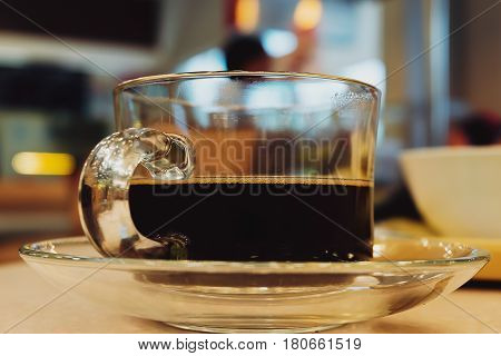 Black Coffee in Crystal Glass on Table Cafeteria Background
