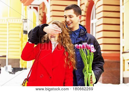 Romantic Date. Man Closed Eyes Of His Girfriend To Make A Surprise. Beautiful Young Couple Walking T