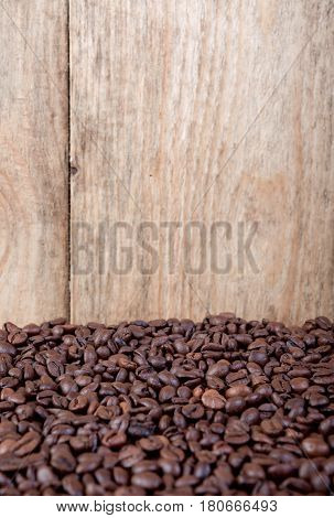 Roasted coffee beans on wood, can be used as a background