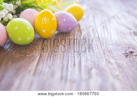 Easter Eggs With Flowers On Rustic Wooden Background