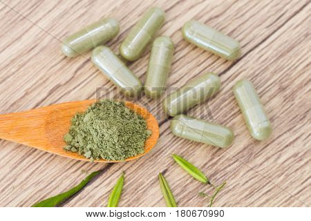 Green Herb Powder Capsules And Erlenmeyer Flask