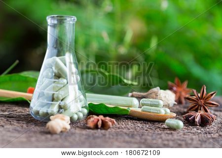 Green Herb Powder Capsules And Erlenmeyer Flask