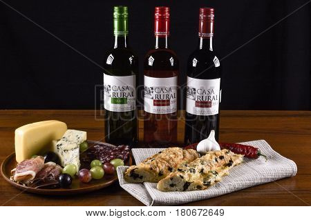 PRIMORSKOE UKRAINE - AUGUST 4 2016: Spanish wines "Casa Rural" (rose wine "Tempranillo" red wine "Tempranillo" and white wine "Viuro" "Casa Rural") blue cheese prosciutto salami French baguette and grapes