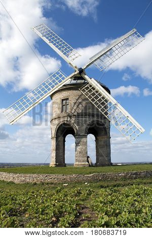 Chesterton West Midlands UK - March 25 2016: Chesterton 17th-century cylindrical stone tower windmill against a blue sky with clouds