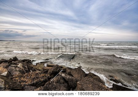 Sunset At The Sea Shore Of A Beach With Rocks And Stormy Waves, Beautiful Seascape At Caspian Sea Ab