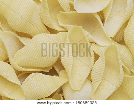 close up of raw uncooked conchiglie jumbo shell pasta food background