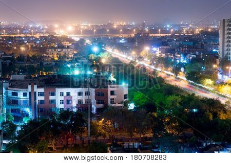 Noida cityscape at night showing lights, buildings and residences. Shows the urbanization and development of Delhi
