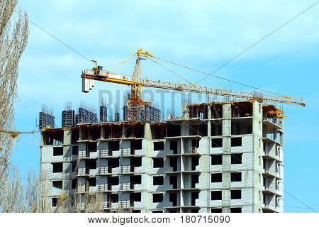 High crane on the construction of a multifamily urban residential building