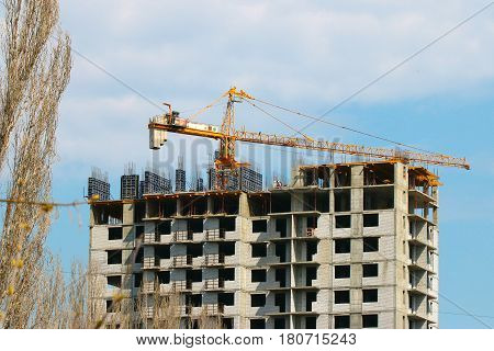 High crane on the construction of a multifamily urban residential building
