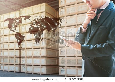 Double Exposure Of Businessman Looking Smart Phone For Analyze And Checking Stock At Logistics Port