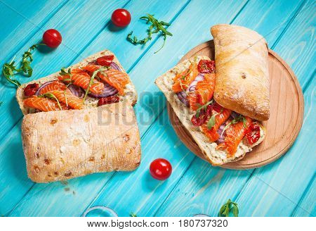 sandwich with smoked salmon on blue wooden table