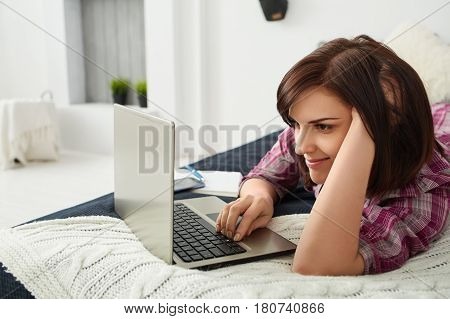 Young freelancer woman using laptop.Happy smiling girl working on line.Work at home.Studying and learning using notebook computer.Enjoy working.Freelance workbusiness people concept.Home office