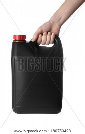 Female hand holding black plastic jerrycan on white background