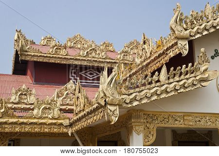Detail of the rich traditional architecture and golden decorations on the facade of the Alodawpyi Monastery in Sittwe Rakhine State Myanmar