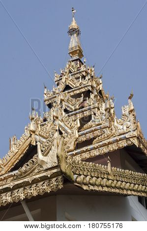 Detail of the rich traditional architecture and golden decorations on the facade of the Alodawpyi Monastery in Sittwe Rakhine State Myanmar