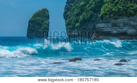 Rock in Tembeling Coastline at Nusa Penida island, Ocean Waves in Front. Bali Indonesia.