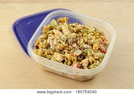 Baked salmon pasta salad with spiral rotini vegetable pasta in plastic storage container
