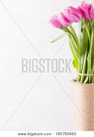 Pink tulips on a light background in handmade Vase. Pink tulip. Tulips. Flowers. Flower background. Flowers photo concept. Holidays photo concept. Copyspace