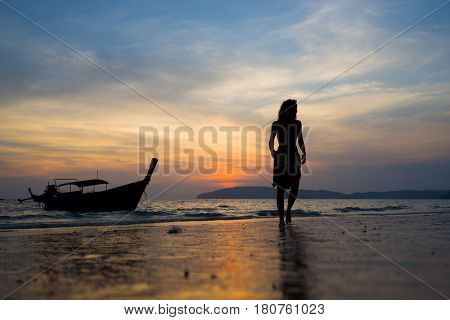 Woman on the beach in Ao Nang Krabi at sunset