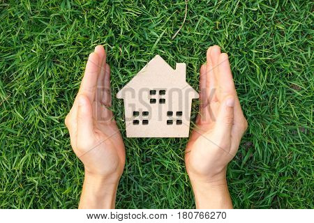 Wooden house on green grass / Eco house