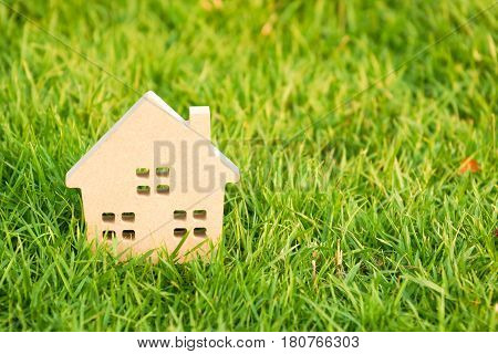 Wooden house on green grass / Eco house