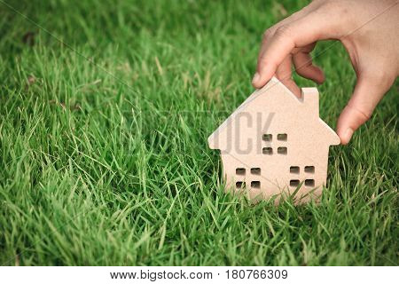 Wooden house on green grass / Eco house
