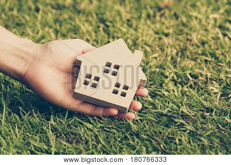 Wooden house on green grass / Eco house