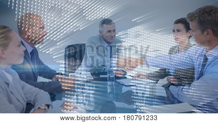 Digital composite of Business meeting with behind blue map graphic overlay against grey background