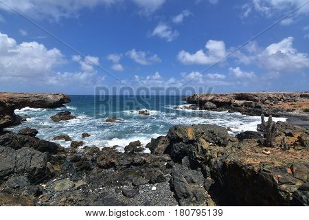 Beautiful view of the black sand stone beach on Aruba's east coast.
