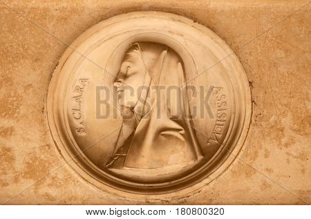 ROME, ITALY - SEPTEMBER 03: Saint Clare of Assisi, bass relief in portico of church dei Santi XII Apostoli in Rome, Italy on September 03, 2016.