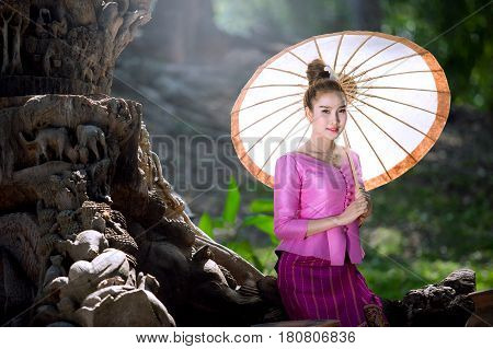 Lao woman in national uniform Lao woman in national costume holding umbrellas