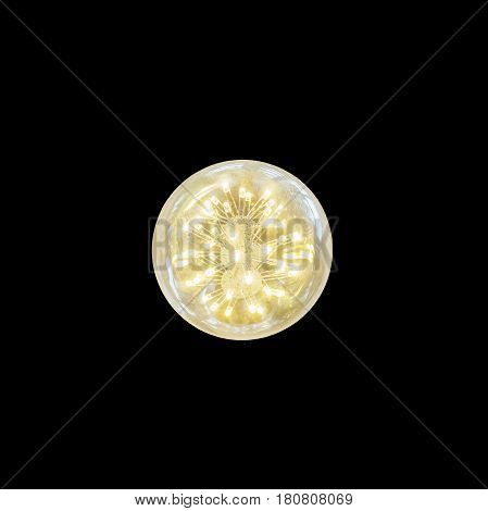 Closeup opening light bulb with yellow light isolated on black background
