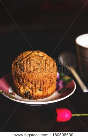 gluten free muffin over a wooden table in a dark set