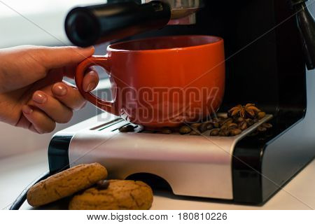 Girl make fresh coffee in a coffee machine with flavoring