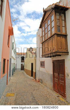 AGULO, LA GOMERA, SPAIN: Cobbled street with colorful facades and a wooden balcony
