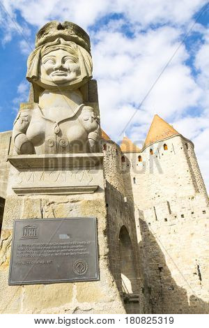 Carcassonne, France - October 20, 2016; The replica of lady Carcas's bust above World heritage Site brass plaque at entrance to castle or fort known as La Cite de Carcassonne France