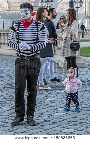 TIMISOARA ROMANIA - MARCH 31 2017: Pantomime couple with painted face present on the street inside the CheckART Carnival organized by the City Hall Timisoara. Union Square.