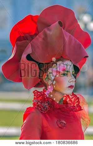 TIMISOARA ROMANIA - MARCH 31 2017: Living statue of a woman multicolor dressed and present on the street inside the CheckART Carnival organized by the City Hall Timisoara. Union Square.
