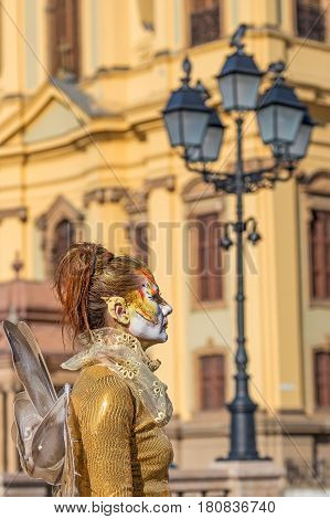 TIMISOARA ROMANIA - APRIL 1 2017: Living statue of a woman multicolor dressed and present on the street inside the CheckART Carnival organized by the City Hall Timisoara. Union Square.