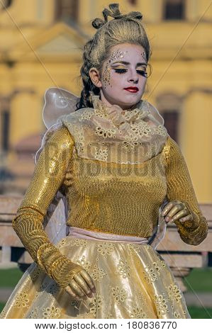 TIMISOARA ROMANIA - MARCH 31 2017: Living statue of a woman multicolor dressed and present on the street inside the CheckART Carnival organized by the City Hall Timisoara. Union Square.