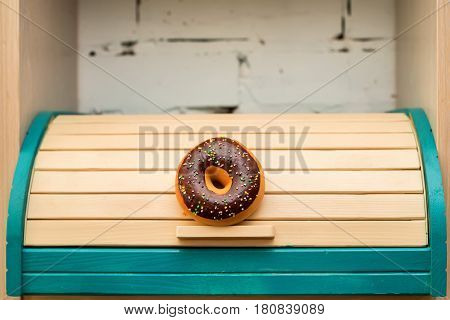 Colorful wooden breadbox decorated with donut in rustic style