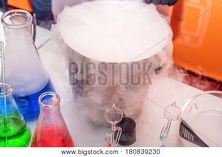 Laboratory expreriment with test-tubes with colored chemical reagents, retorts and flasks
