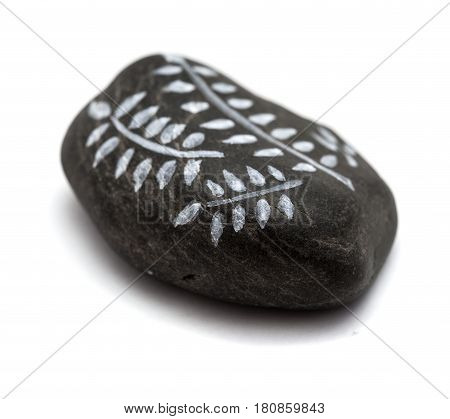 pebble painting - lava pebble with floral design on white background