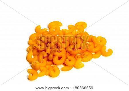 A lot of pasta. Dry pasta. Scattered pasta. Pasta background. Pasta in form of shells. Macaroni products. Macaroni background. Food background.