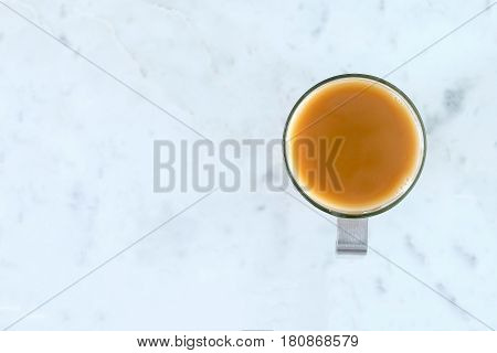 Milky Tea in Glass Cup on Marble Surface