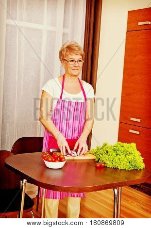 Woman cut red onion on cutting board