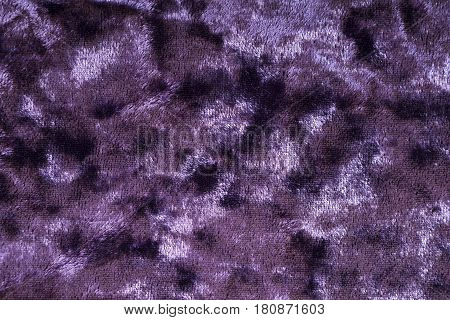 Purple background from a soft textile material. Sheathing fabric with natural texture macro. Cloth backdrop.