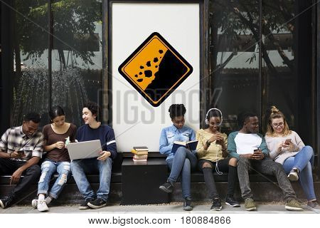 Group of Friends Sitting with Rockfall Beware Attention Behind