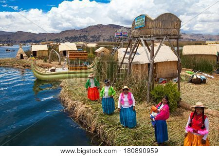 PERU - MAY 11, 2015: Unidentified women in traditional dresses welcome tourists in Uros Island