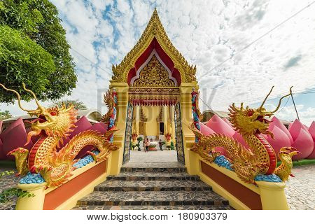Colorful Buddhist Temple Entrance With Dragons, Lotus Flower And Golden Decoration